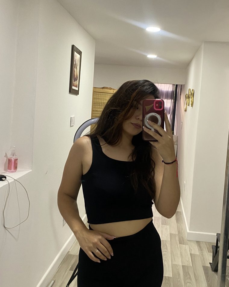Olivia taking a mirror photo in her hallway